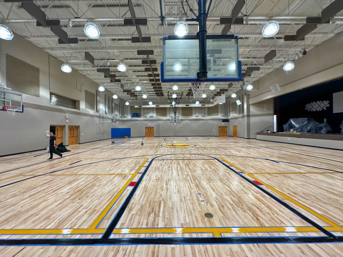 In the process of refinishing a maple basketball court in the Michiana area. Two coats of sealer have been applied and the floor is in the middle of having the lines painted.