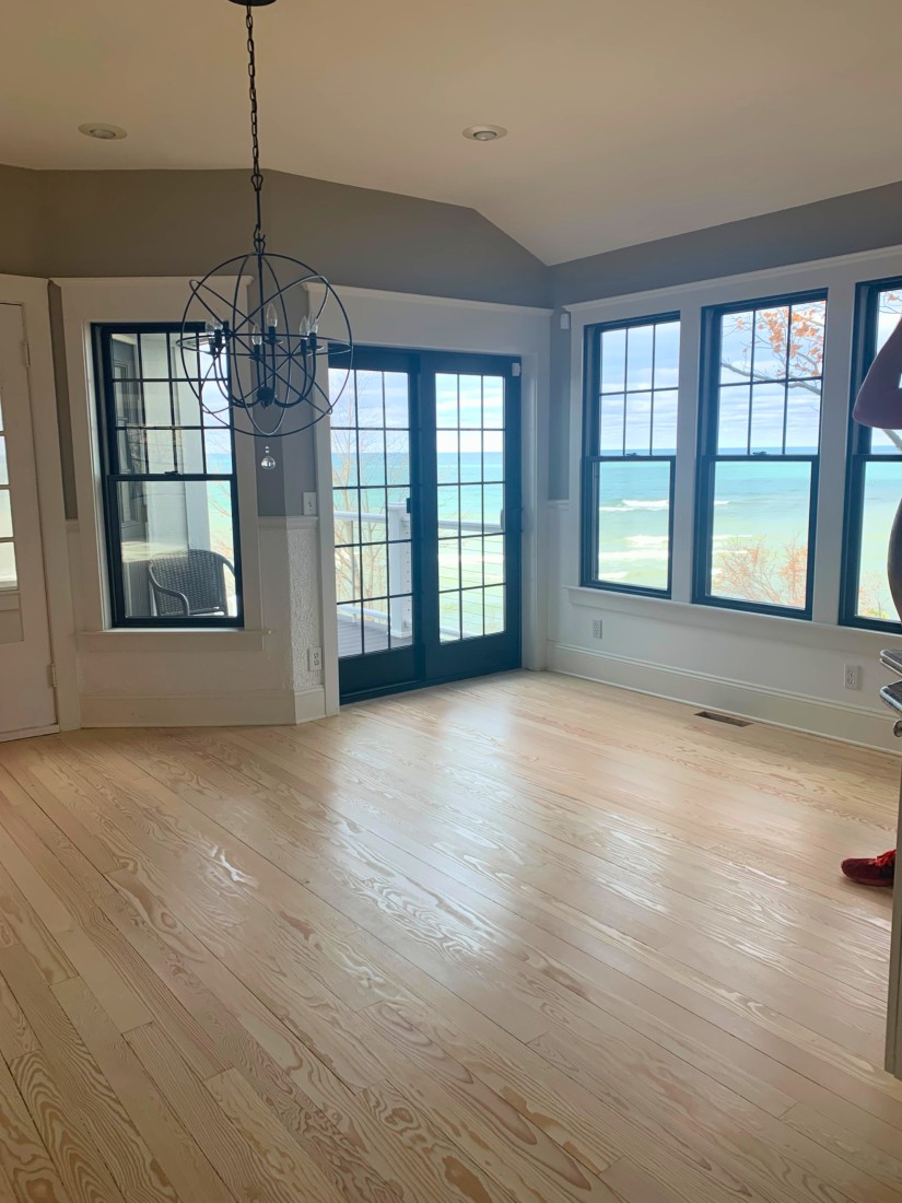 Pine wood flooring stained white in a home overlooking Lake Michigan. 